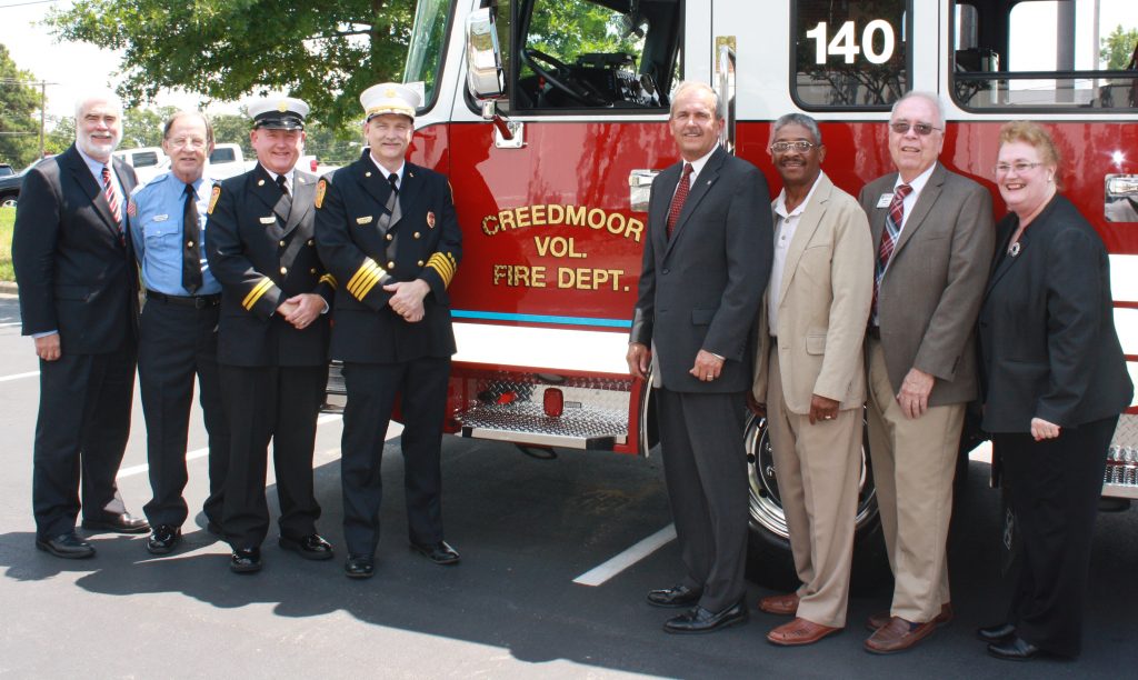 From left to right: Tom Currin, attorney, Carl Norgaard, secretary, Billy Fisher, asst. fire chief,  Jimmy Minor, fire chief, Wake Electric board members Mike Dickerson, Allen Nelson, and Joe Hilburn, and Cynthia Currin, Wake Electric attorney.