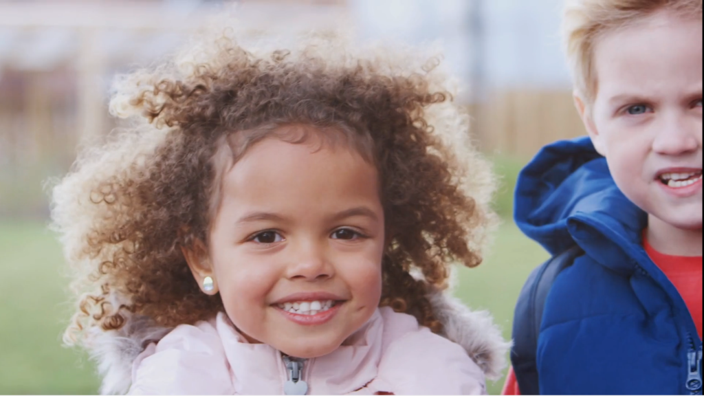 Small kids smiling in coats