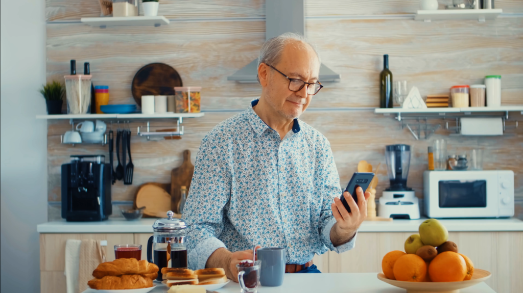 Screenshot of individual drinking coffee and using smart phone