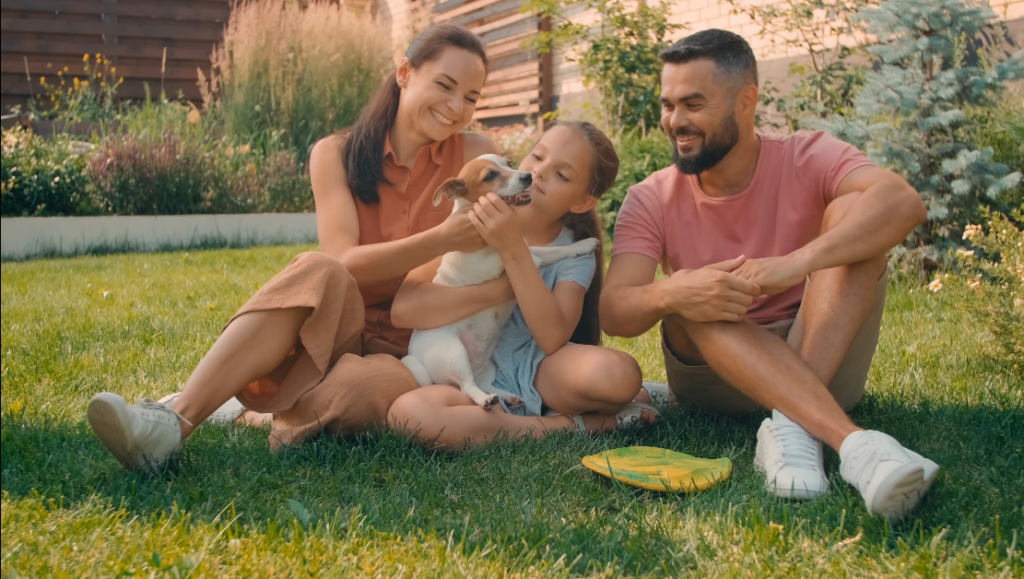 Family outside with dog.