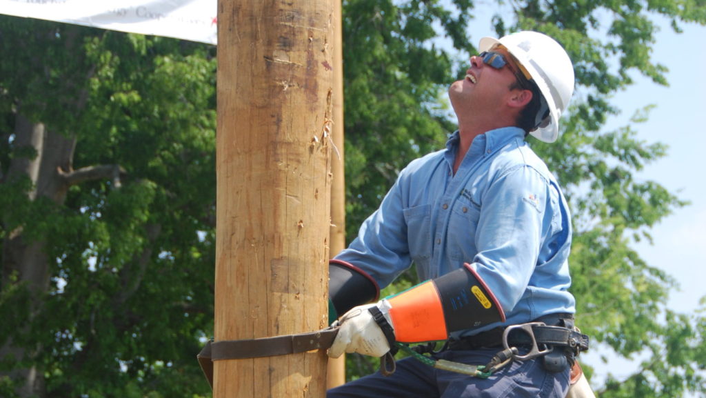 Wake Electric lineman climbing pole at Pole Top Rescue competition